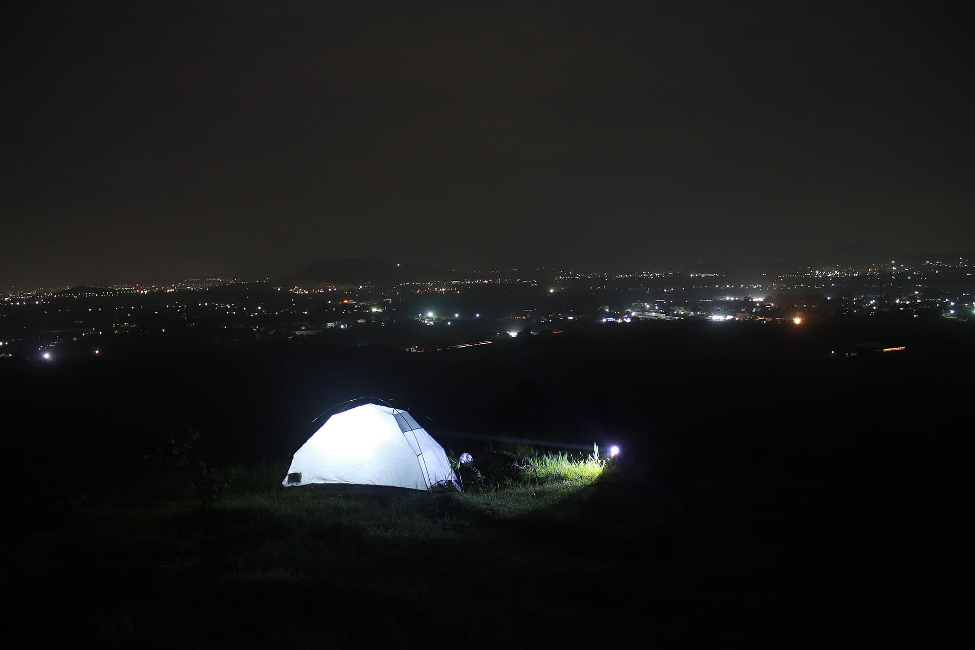 A tent pitched under a clear night sky