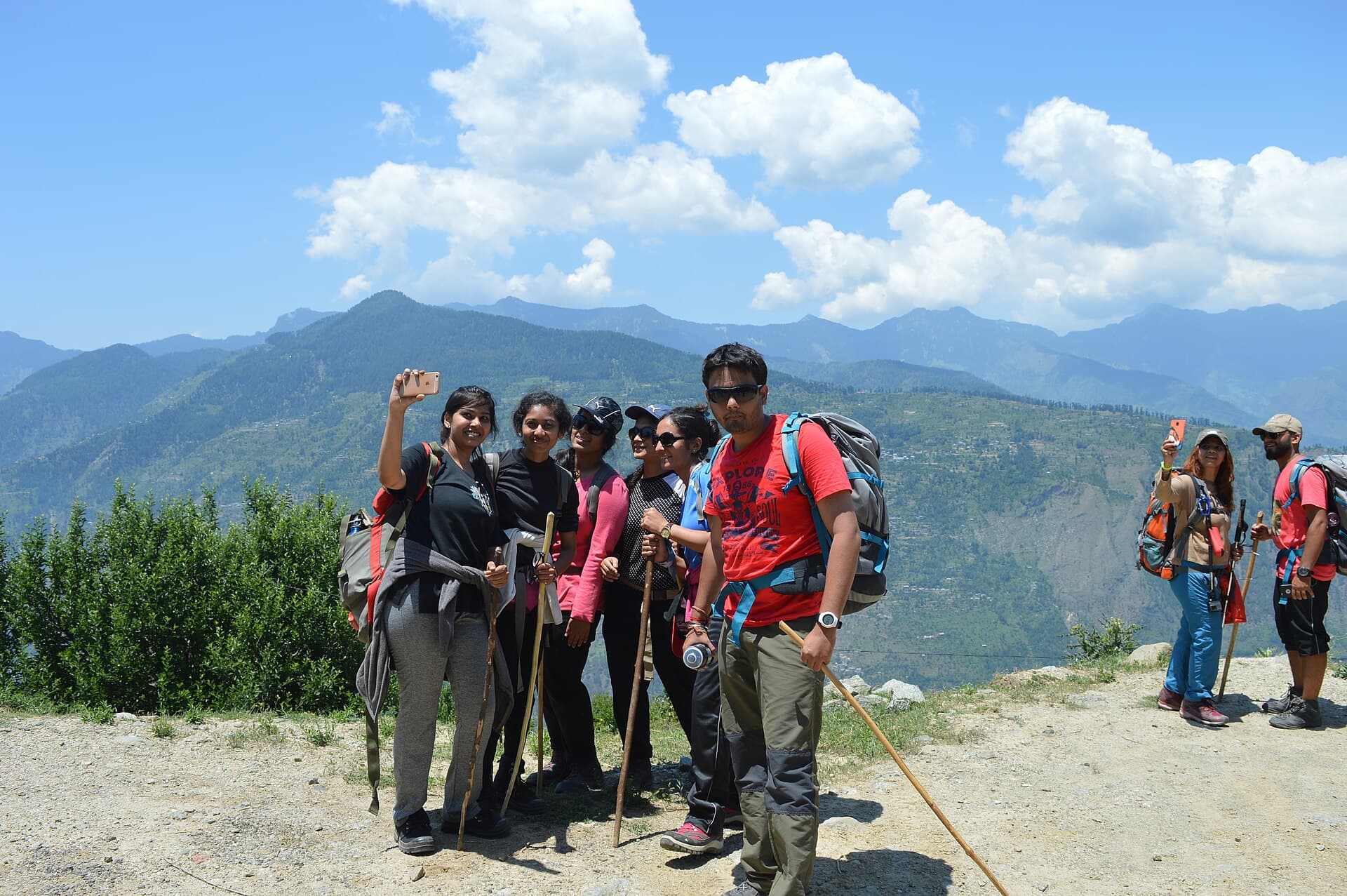A group of trekkers pausing on a mountain trail