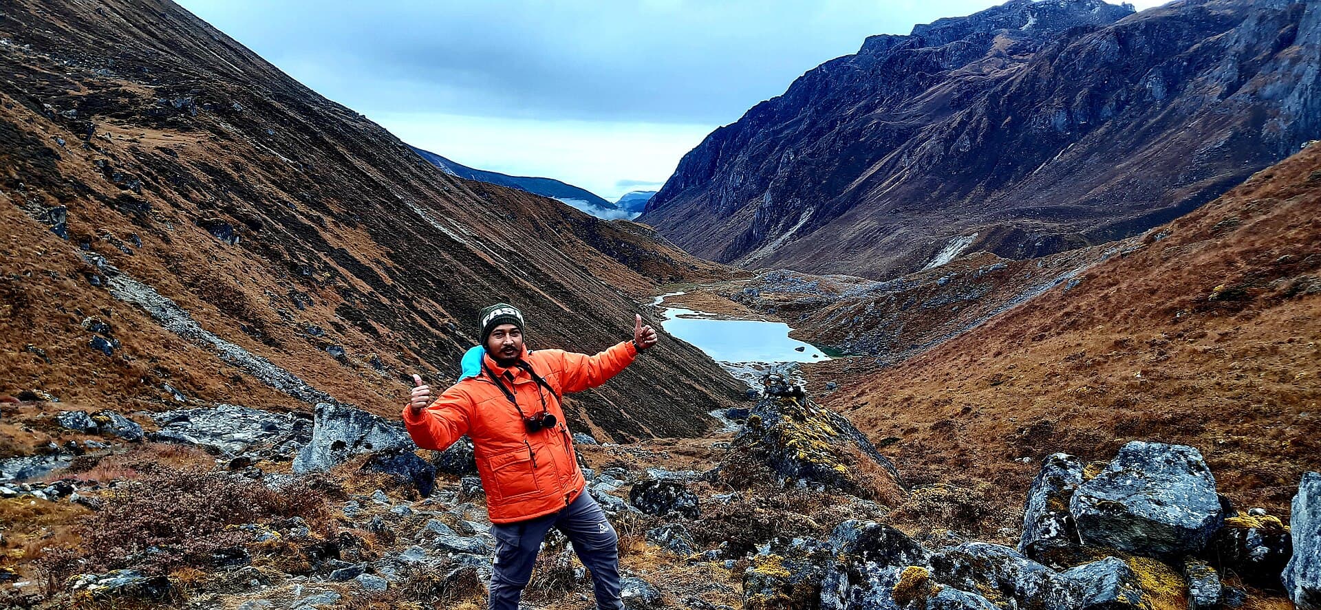 A trekker pausing on the Goecha La trail, Sikkim