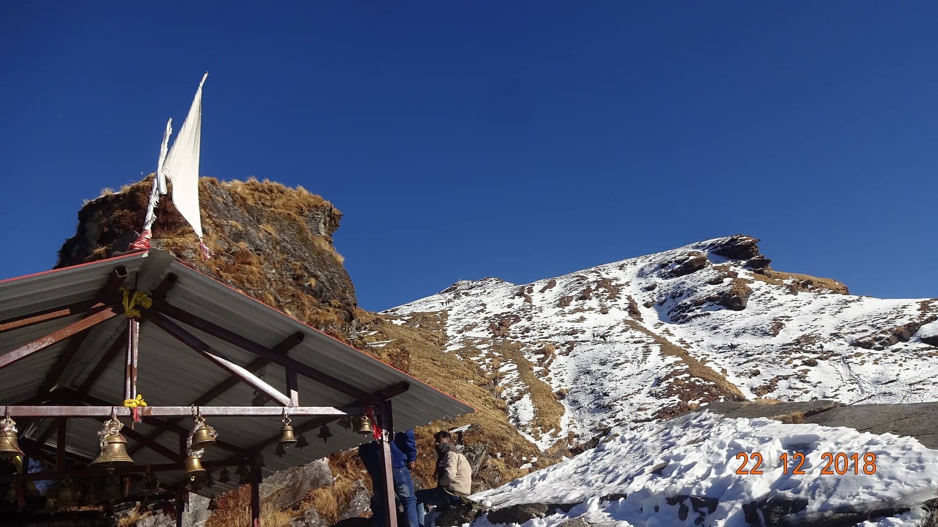 Chandrashila peak seen from Tungnath temple against a clear Himalayan sky