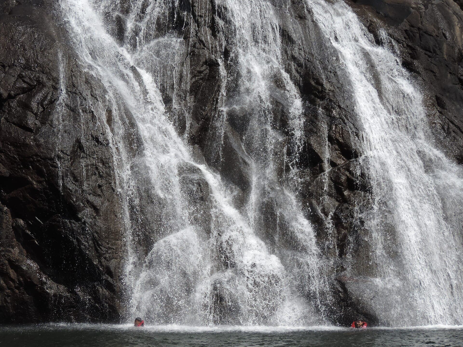 Wide view of Dudhsagar Falls and the surrounding Western Ghats valley from across the gorge