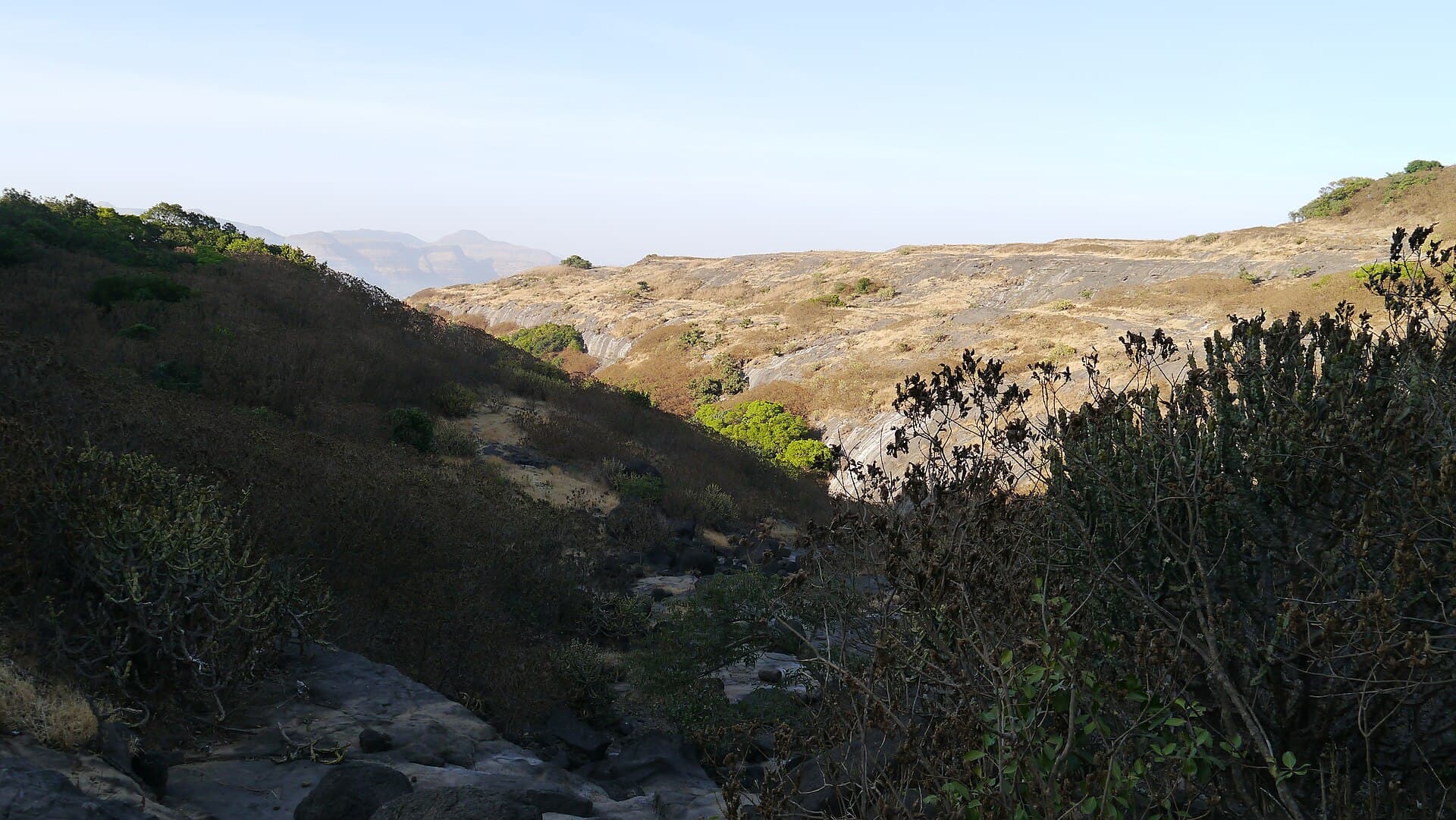 Trail crossing open ground toward Kokan Kada