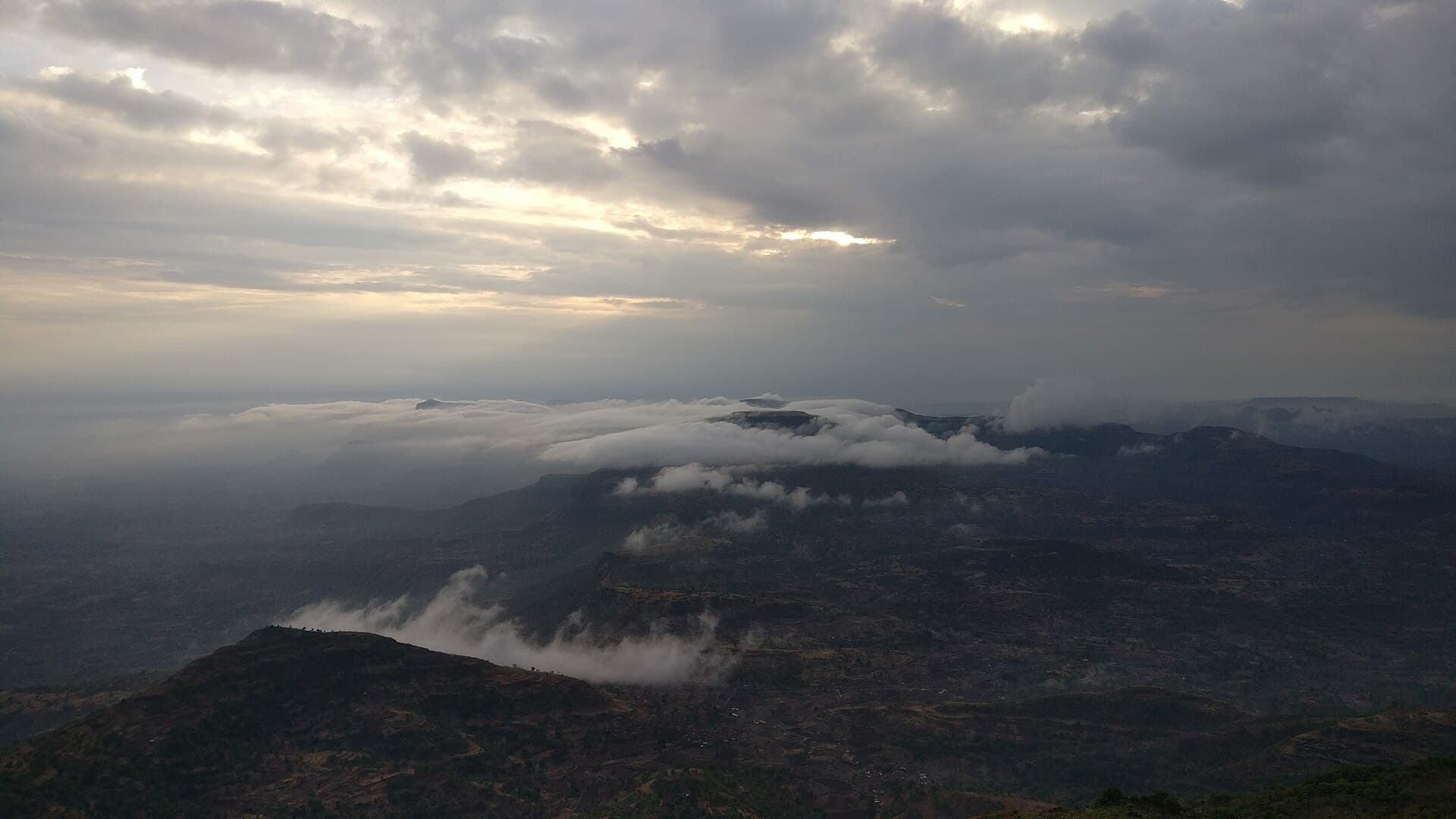 Sunrise light over the ridgeline seen from Kalsubai peak
