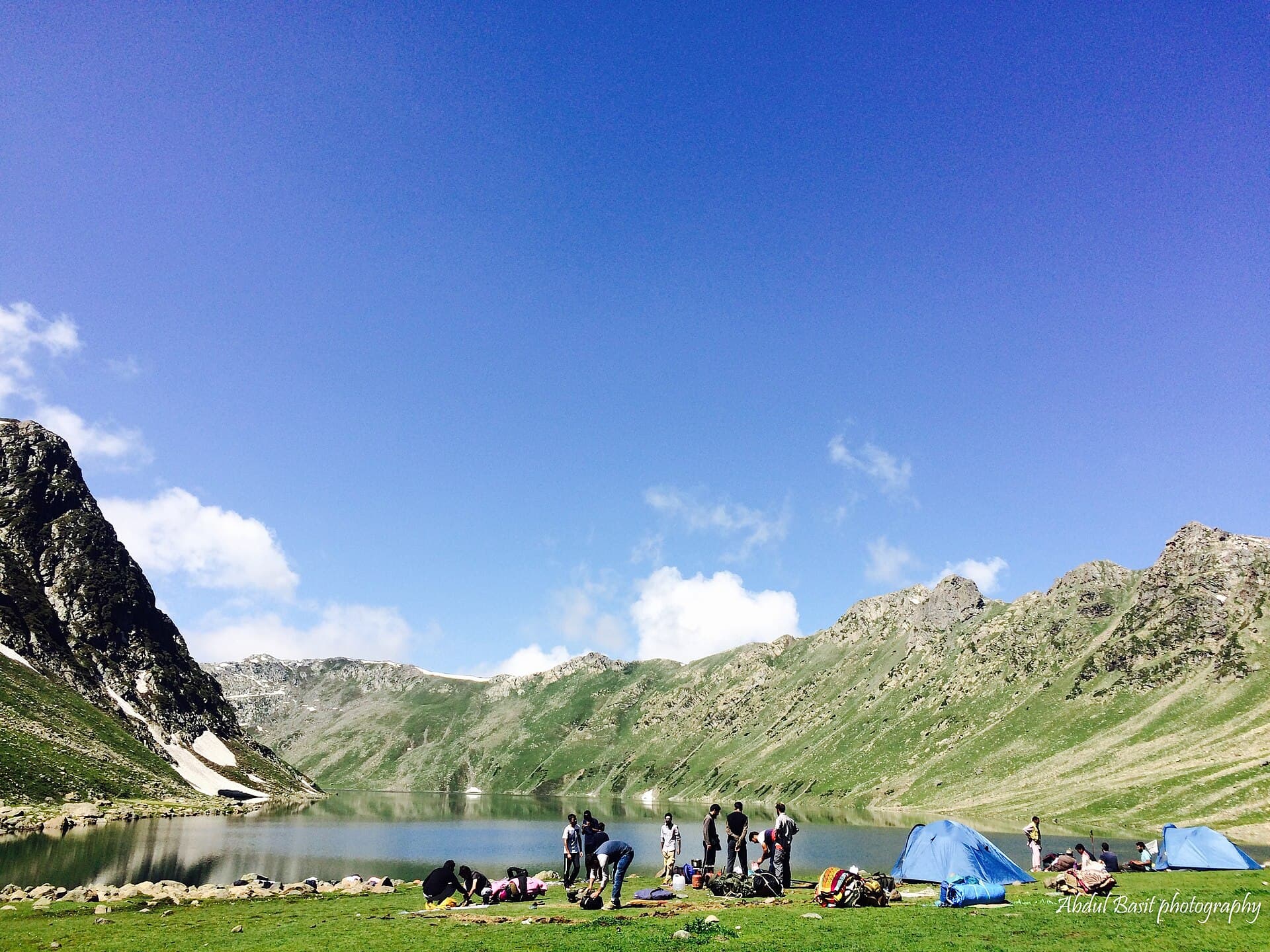 A trekking camp beside Tarsar Lake with the surrounding ridgeline behind